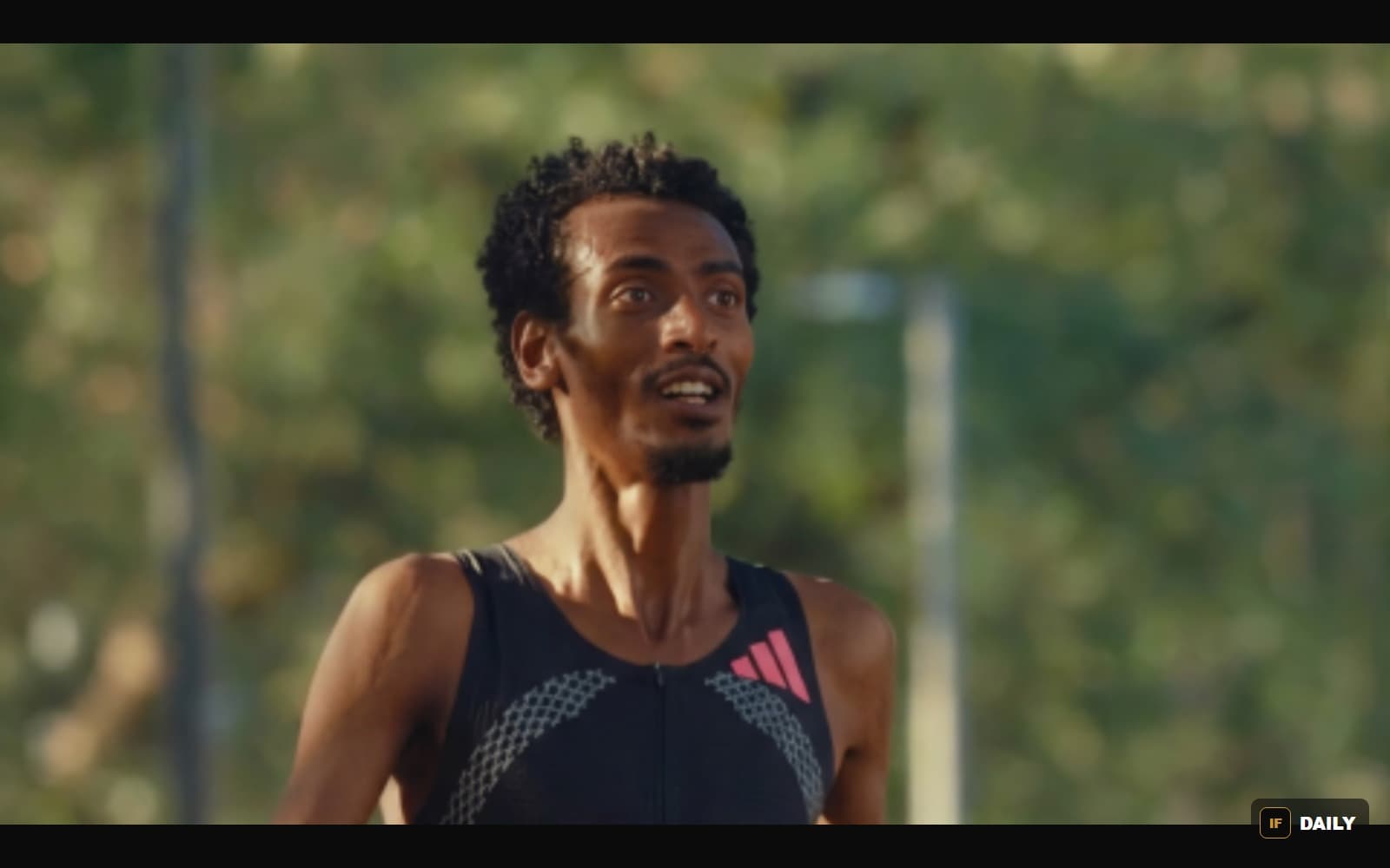 Close-up portrait of Yomif Kejelcha in racing kit