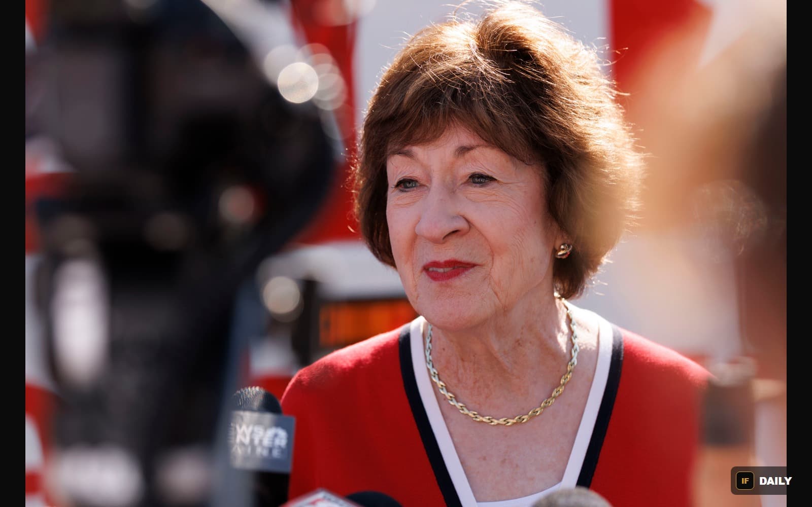 Senator Susan Collins speaking to reporters outdoors near television news microphones
